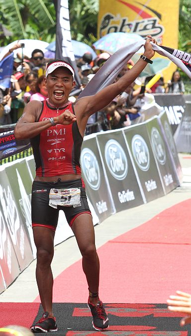  AUGUST Benedicto of the Philippines whoops it up at the finish as he defends his Filipino Elite crown.