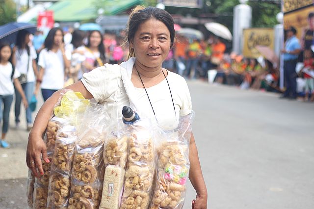 Abet Patalinghug sells her chicharon along the Cobra IronMan 70.3 route in Lapu-Lapu City. 