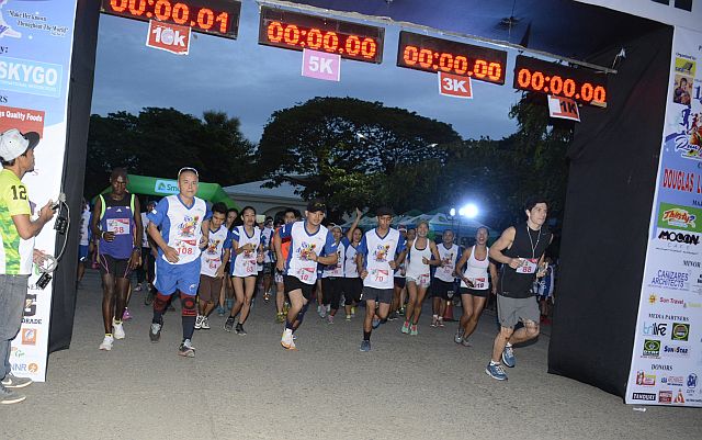 Runners competing in the 10-kilometer race of the Run for Mary leave the finish line at the Redemptorist Church grounds. (CDN PHOTO/CHRISTIAN MANINGO)