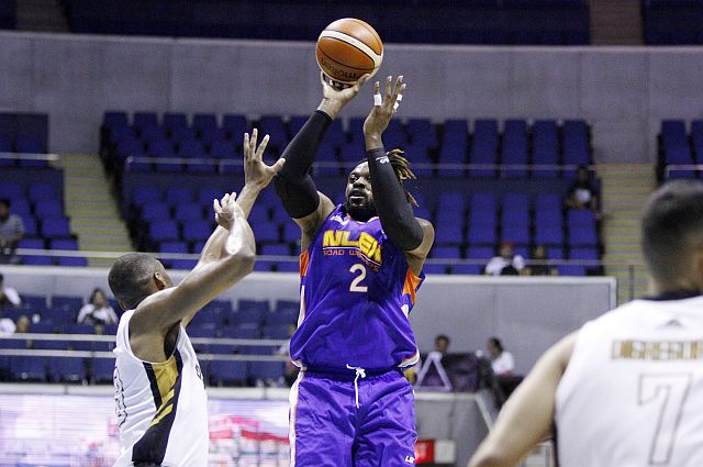NLEX import Henry Walker puts up a shot against James White of Mahindra. (PBA IMAGES)