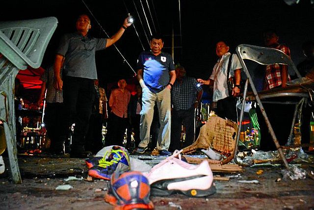 President Duterte visits the night market on Roxas Avenue in Davao City where 14 people were killed and 68 others injured after an explosion tore through what Davaoeños call their happy place. (Malacañang Photo) 