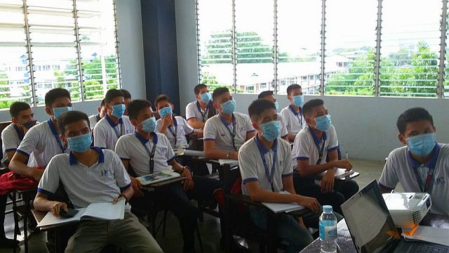 A class from are wearing face masks 