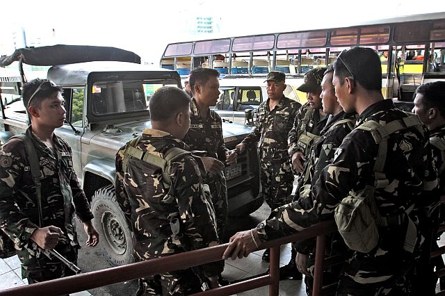 Cebu authorities call on the public to stop making prank calls on police hotlines so as not to disrupt legitimate government operations against suspected terrorists and drug dealers. In this photo, soldiers of AFP Central Command’s  47th Infantry Battalion  are shown securing the South Bus Terminal as police and military go on heightened alert following the Davao City bombing last Friday. (CDN PHOTO/JUNJIE MENDOZA)