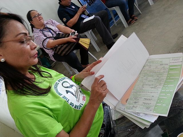 Development Management officer Hazel Torrefiel of NCIP checks the birth certificates of Sama-Bajaus prior to its distribution. (Contributed Photo) 