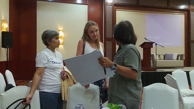 Environmentalists, lawyer Gloria Ramos (left) and Gary Cases, confer with explorer Alexandra Costeau (center) during a break in the Ocean Talk forum in Cebu City (CDN PHOTO/MICHELLE JOY PADAYHAG).