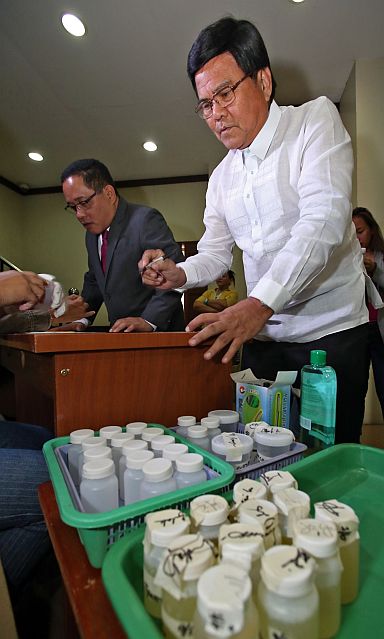 Vice Mayor Edgardo Labella (right) and Councilor Dave Tumulak submit their urine samples during a drug test at City Hall. (CDN PHOTO/JUNJIE MENDOZA)