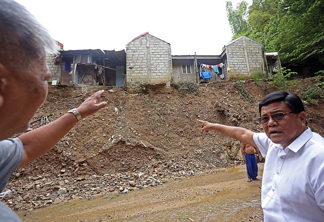 Vice Mayor Labella points to the area in Sitio Lower Tac-an, Barangay Budlaan where soil erosion occurs (CDN PHOTO/LITO TECSON).