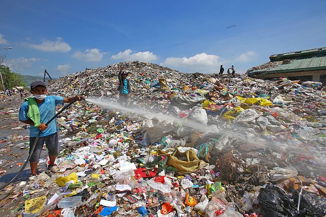 Personnel of the Department of Public Services (DPS) start a massive spraying of  enzymes at the Inayawan Landfill to lessen,  if not totally eliminate,  the  smell from the mountains of garbage (CDN PHOTO/JUNJIE MENDOZA).