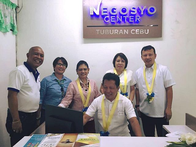 Mayor Democrito Diamante (seated) tests the business name registration system at the newly opened Negosyo Center in Tuburan town, midwest Cebu. Present during yesterday’s Negosyo Center opening were Vice Mayor Danilo Diamante (from left, standing), Trade and Industry Provincial Director Maria Elena Arbon, Trade and Industry Assistant Regional Director Nelia Navarro, Tuburan Administrative Officer Rowena Borneo and Trade and Industry Business Development Chief Elias Tecson (DTI CEBU FACEBOOK).