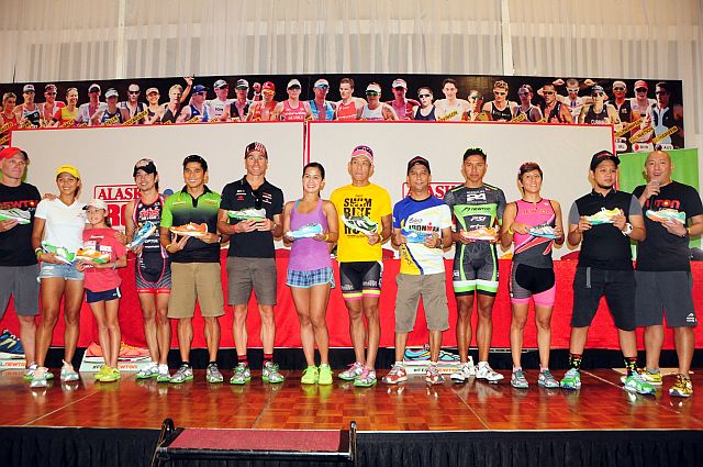 Doray and Mark Ellis (from left) with daughter, IronKids champion Kira; JP Tuasonof TRS Tri Team;  Craig Alexander;  Edward Luna, 2nd place M45–49; Julian Valencia, certified IronMan & Natural Running Coach; Vanj Endaya, multi-awarded age group triathlete; Romel Espinoza from Running Photographers; Amale Jopson, two-time Boston marathon qualifier; Ronald Molit, 2nd place male 30–34; and Ironman host Chiqui Reyes show their support to Newton Running. (CONTRIBUTED)