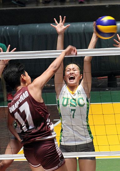 Mary Jane Igao (7) of USC puts up a block against Jessa T. Semblante (17) of SWU-Phinma during their CESAFI women’s volleyball match at the USC Gym. (CDN PHOTO/JUNJIE MENDOZA)