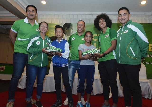 Milo officials give away shoes to underprivileged children during a press conference for the 40th National Milo Marathon at the Cebu Grand Hotel. In the photo are (from left) Milo VP for Sports Andrew Neri, Olympian Mary Joy Tabal, Cebu leg organizer Ricky Ballesteros, race director Rio dela Cruz of Run Rio Inc. and Milo Sports Executive Robbie de Vera (CDN PHOTO/CHRISTIAN MANINGO).
