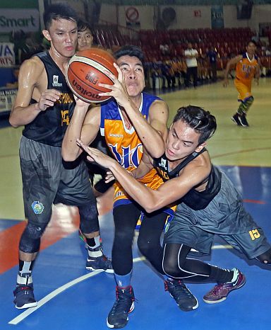 Jumike Casera of the University of Cebu Baby Webmasters is fouled by Jomari Ranuco of the Don Bosco Greywolves in the high school division match of the 16th Cesafi basketball tournament yesterday at the Cebu Coliseum. (CDN PHOTO/LITO TECSON)