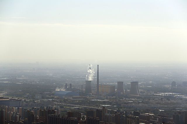 White smoke billows from a coal-fired power plant near the residential buildings in Beijing, Saturday, Sept. 3, 2016. China announced that it has ratified the emissions-cutting agreement reached last year in Paris (AP).
