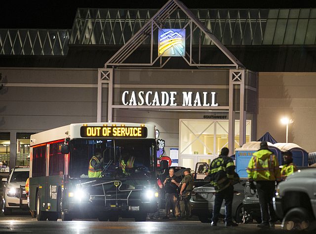 Emergency personnel stand in front of an entrance to the Cascade Mall at the scene of a shooting where several people were killed Friday in Burlington, Washington. (AP Photo)