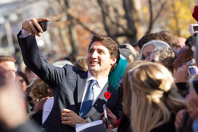 Canadian Prime Minister Justin Trudeau shows that he is comfortable jumping into crowds to gladhand and pose for selfies (AFP).