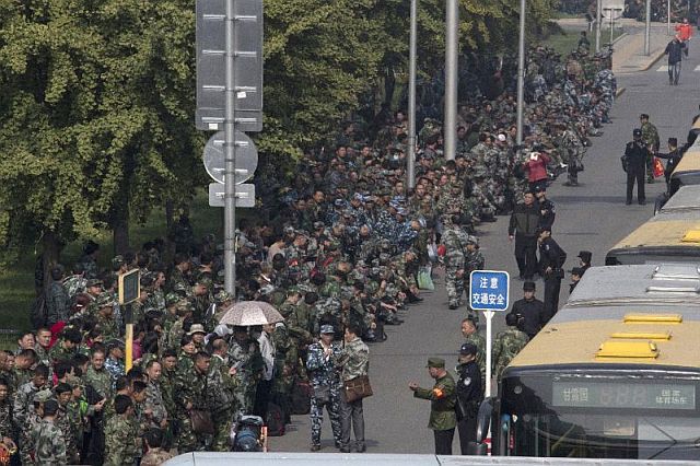 Hundreds of protesters in green fatigues gather outside the Chinese Ministry of National Defense in Beijing in this October 11 photo (AP).