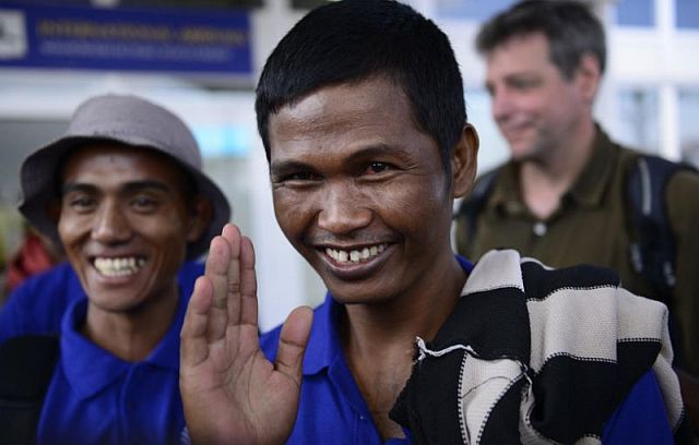 Sailors who had been held hostage by pirates for more than four years, smile as they arrive at the airport in Nairobi, Kenya Sunday (AP).