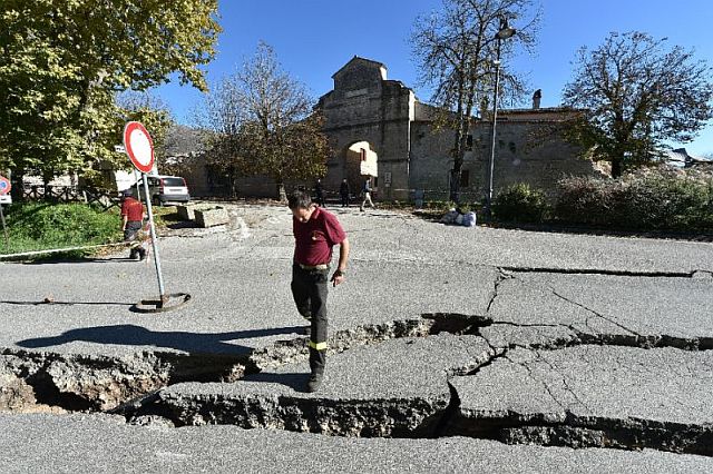 A fireman looks at cracks in the road outside Norcia, central Italy after a 6.6-magnitude earthquake struck on October 30, 2016 (AFP).