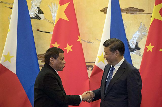 Philippine President Rodrigo Duterte, left, and Chinese President Xi Jinping shake hands after a signing ceremony in Beijing, China, Thursday, Oct. 20, 2016. Duterte was meeting Thursday with Xi in Beijing as part of a charm offensive aimed at seeking trade and support from the Asian giant by setting aside a thorny territorial dispute. (AP Photo/Ng Han Guan, Pool)
