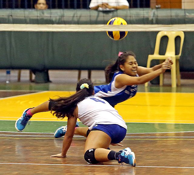 Two Sacred Heart School-Ateneo de Cebu spikers dive to save the ball during their knockout semifinal match against the Southwestern University Baby Cobras in the Cesafi girls volleyball tournament at the University of San Carlos Main gym yesterday (CDN PHOTO/LITO TECSON).