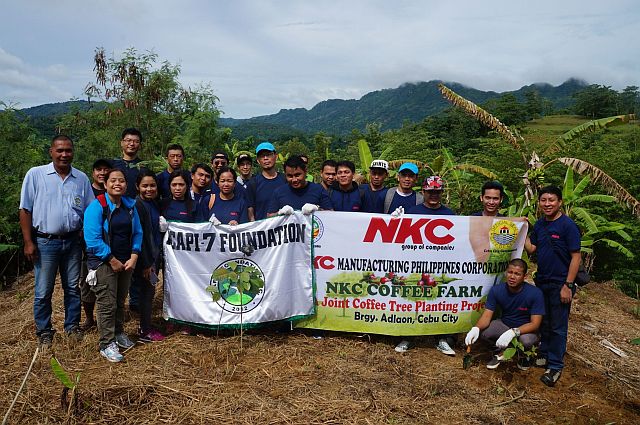 NKC employees led by company president Taiji Nishiinkyo pose during their tree-planting activity in Adlaon.  (CONTRIBUTED PHOTO) 
