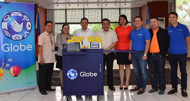 Globe showcases the mobile digital laboratory package that each public school under the Global Filipino School Program receives for teaching engagements. Among those present during the Adopt-A-School program partnership activity and GFS launch are Lemuel Dayo, Principal of Sico 1.0 National High School, San Juan, Batangas; Yoly Crisanto, Globe SVP for Corporate Communications; and Fernando Esguerra, Globe Director for Citizenship (CONTRIBUTED PHOTO). 