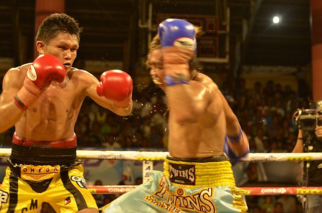 Jason Canoy (left) rocks Jetly Purisima with a left hook en route to scoring a fifth-round technical knockout win in the main event of “Rumble in Balamban” last Friday in Balamban town, Cebu. (CONTRIBUTED)