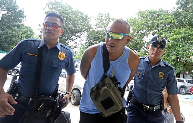 Driver Adhman Sigue Canangca-an was escorted by police at the Cebu Provincial Prosecutor’s Office.  (CDN Photo/Lito Tecson)
