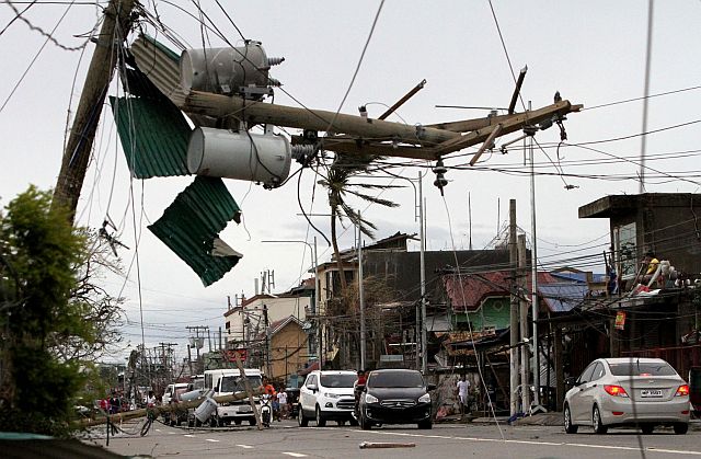  Some of the electric posts block the road along Maharlika Highway in Tuguegarao, Cagayan after being toppled by strong winds brought by typhoon Lawin (INQUIRER).
