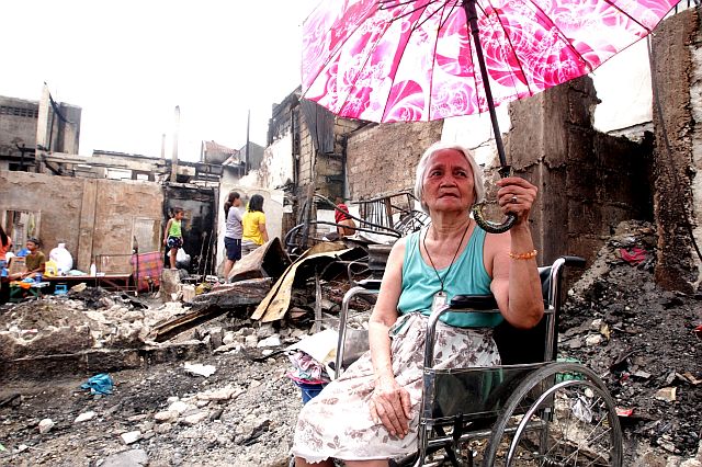 One of the fire victims, Cecilia Gahites, 86, sits on her wheelchair near where her house once stood. Cebu City Mayor Tomas Osmeña announced that they would look for ways to double the financial assistance for fire victims.  (CDN PHOTO/TONEE DESPOJO)