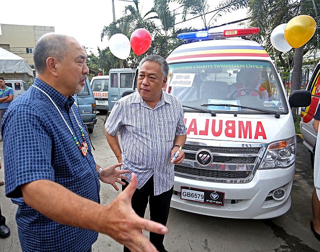 Jose Jorge Corpuz, Philippine Charity Sweepstakes Office (PCSO) chairman, turns over four ambulances to Cebu province represented by Cebu Gov. Hilario Davide III at the PCSO-Cebu office in Cebu City (CDN PHOTO/Lito Tecson).