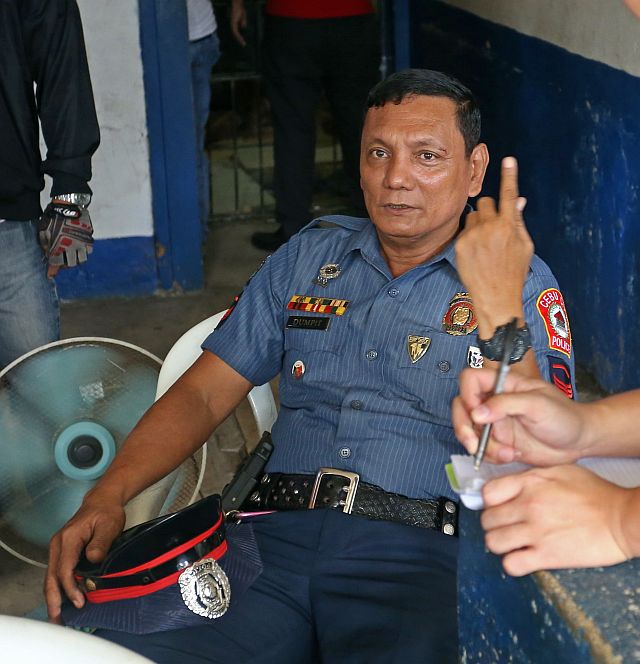 SPO1 Adonis Dumpit, while taking a breather from processing his transfer documents,  takes time to answer questions from the media regarding his return to the Cebu City Police Office (CCPO) (CDN PHOTO/LITO TECSON).