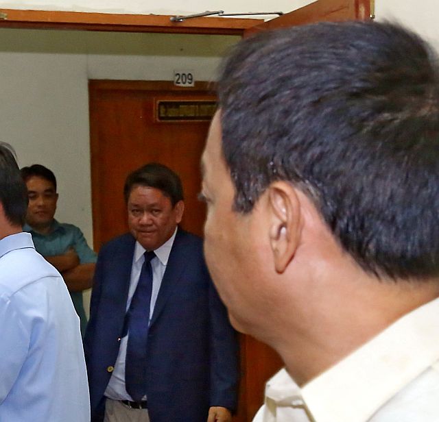 Cebu City Councilor Joel Garganera (back to camera) and Mayor Tomas Osmeña lock eyes as the latter arrives in the hearing room of the Court of Appeals where both camps argued on the impending closure of the Inayawan Landfill (CDN PHOTO/JUNJIE MENDOZA). 