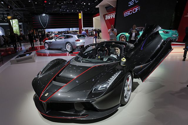 The New Ferrari LaFerrari Aperta is on display at the Paris Auto Show in Paris, France, Friday, Sept. 30, 2016. This limited edition of the Ferrari's LaFerrari supercar offers the pleasures of open-top driving in a car that performs pretty much like a Formula One racer. (AP Photo/Christophe Ena)