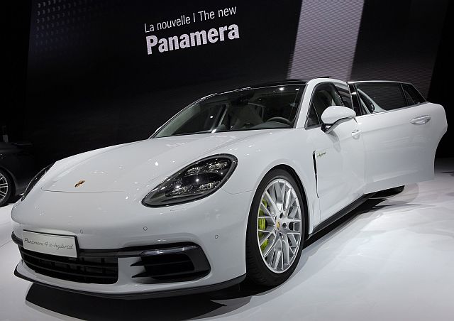 The new Porsche Panamera 4-E-Hybrid is on display at the Paris Auto Show in Paris, France, Friday, Sept. 30, 2016. The all-wheel drive car draws on the technology used in the company's 918 Spyder supercar so that the electric motor continually adds power; the car accelerates to 100 kph (62 kph) in just 4.6 seconds and reaches a top speed of 270 kph (168 mph). (AP Photo/Christophe Ena)