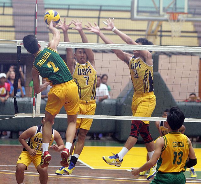 CESAFI VOLLEYBALL/OCT 30,2016: Jay Tadatada hummer the ball against defending University of Souther Philippines Foundation's Samlet Booc (7) and Earl Cansico during the championship match against University of San Carlos. USPF won the match.(CDN PHOTO/TONEE DESPOJO)