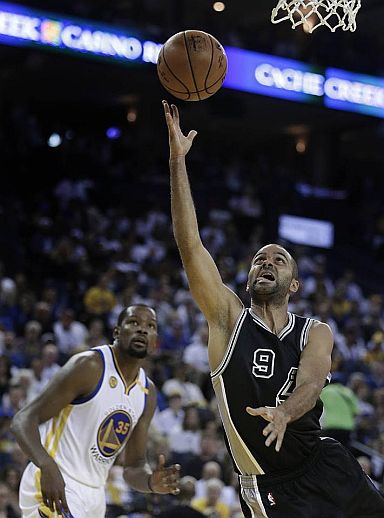 San Antonio's Tony Parker lays it up as Golden State's Kevin Durant looks on. (AP)