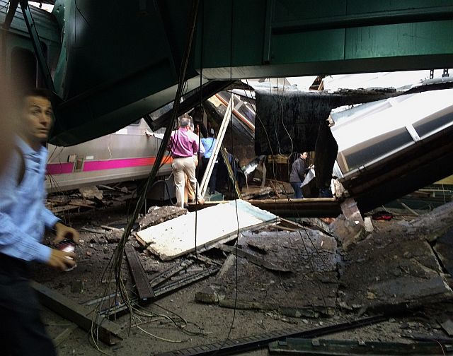 In a photo provided by William Sun, people examine the wreckage of a New Jersey Transit commuter train that crashed into the train station during the morning rush hour in Hoboken, New Jersey. (AP)
