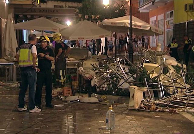 In this grab taken from a video provided by Wikono, emergency services stand outside the café La Bohemia after an explosion in Malaga, Spain. (AP)