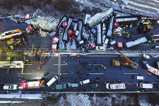 This Monday photo released by Xinhua News Agency shows rescuers working near vehicles colliding on the Pingyang section of Beijing-Kunming expressway in north China’s Shanxi Province (AP PHOTO). 