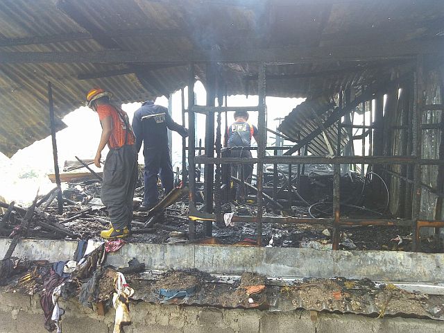 Firemen inspect the second floor of the two-storey house (CDN PHOTO/JUNJIE MENDOZA). 