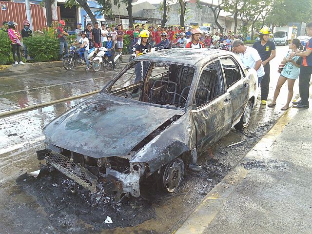 A Kia sedan was destroyed after it caught fire near a mall at past 3 p.m. on Friday (CDN PHOTO/JUNJIE MENDOZA). 