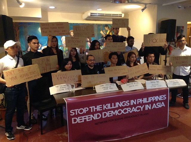 Participants from the Southeast Democracy Asia hold up placards expressing their condemnation of extrajudicial killings in the Philippines and in Asia (CDN PHOTO/DOMINIC YASAY). 