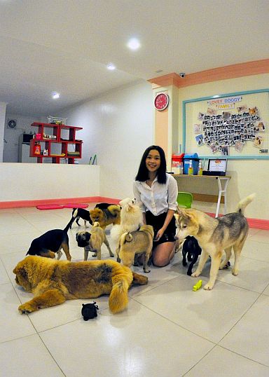 Monica Ingan, owner of  Lovey Doggy Cafe, and her 13 fur babies