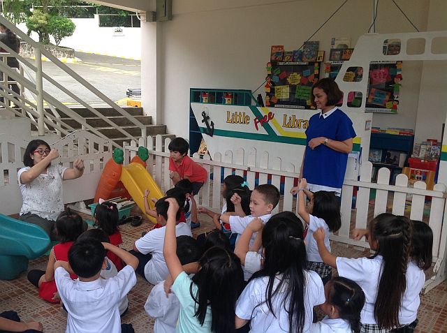 Education consultant Maribeth Villarin conducts story telling for the children.