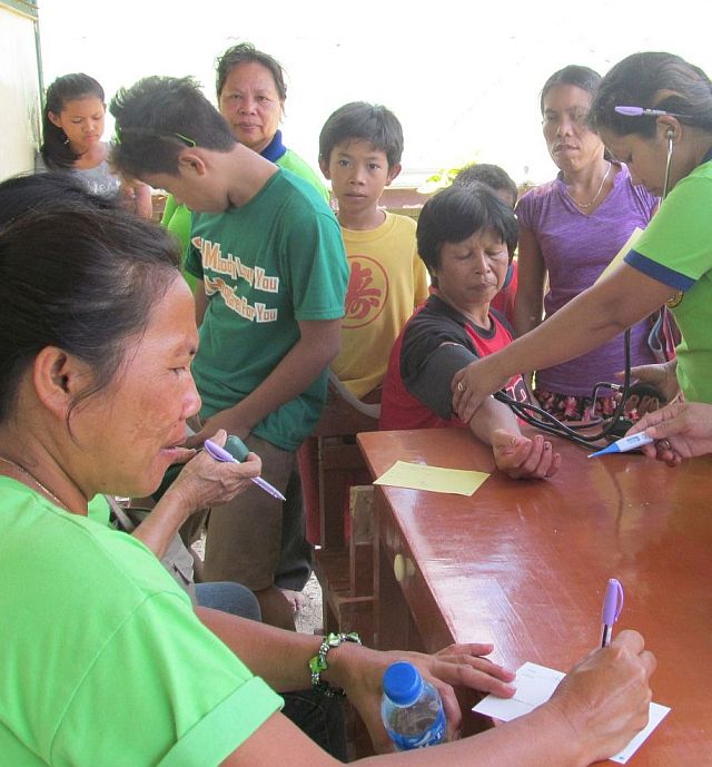 Volunteers attend to residents during their medical mission in Barangay Bugho, San Fernando, Cebu (CONTRIBUTED PHOTO).  
