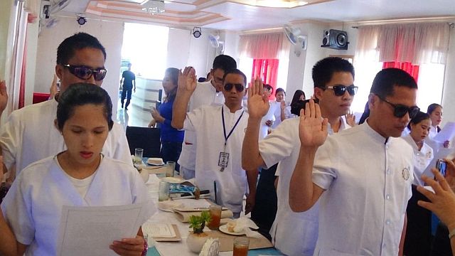 The nine visually impaired trainees of the Area Vocational Rehabilitation Center take oath as licensed massage therapists. (CONTRIBUTED)