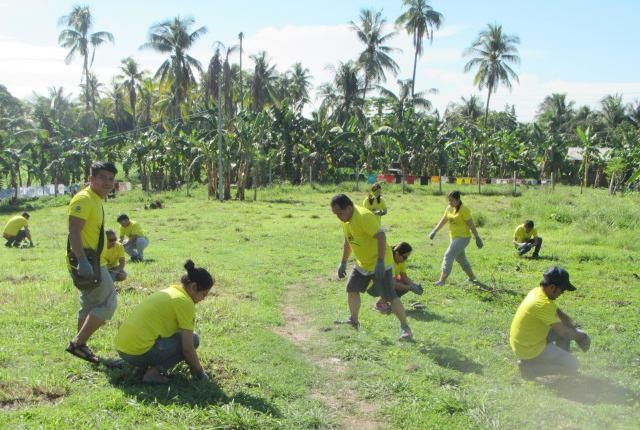 Employees of Taiheiyo Cement and Solid Earth plant trees in San Fernando town. (CONTRIBUTED PHOTO)