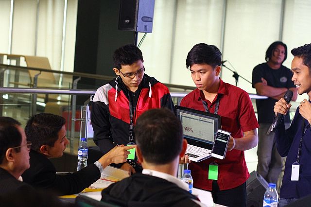 Team Pentagon demonstrates their winning solution, PLDT TechGo, to the judges. (CONTRIBUTED PHOTO)